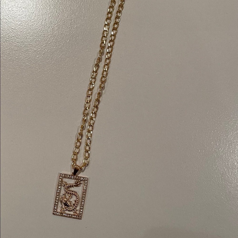 gold necklace with diamond dragon pendent